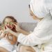 A mother and daughter enjoy a relaxing spa day at home with cucumbers and laughter.